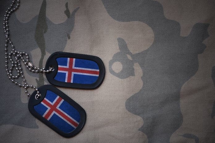 Military dog tags customized with the Icelandic flag over a camo fabric