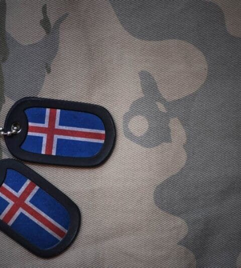 Military dog tags customized with the Icelandic flag over a camo fabric