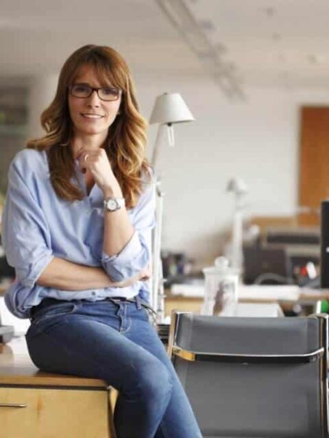 Redheaded Icelandic woman sitting in office