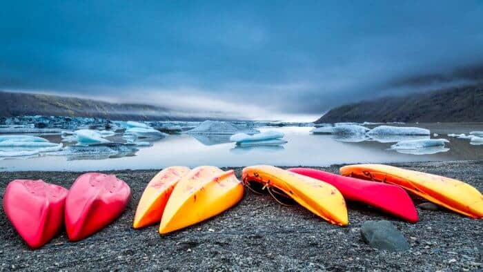 Kayaks in Iceland overlooking a glacier lake