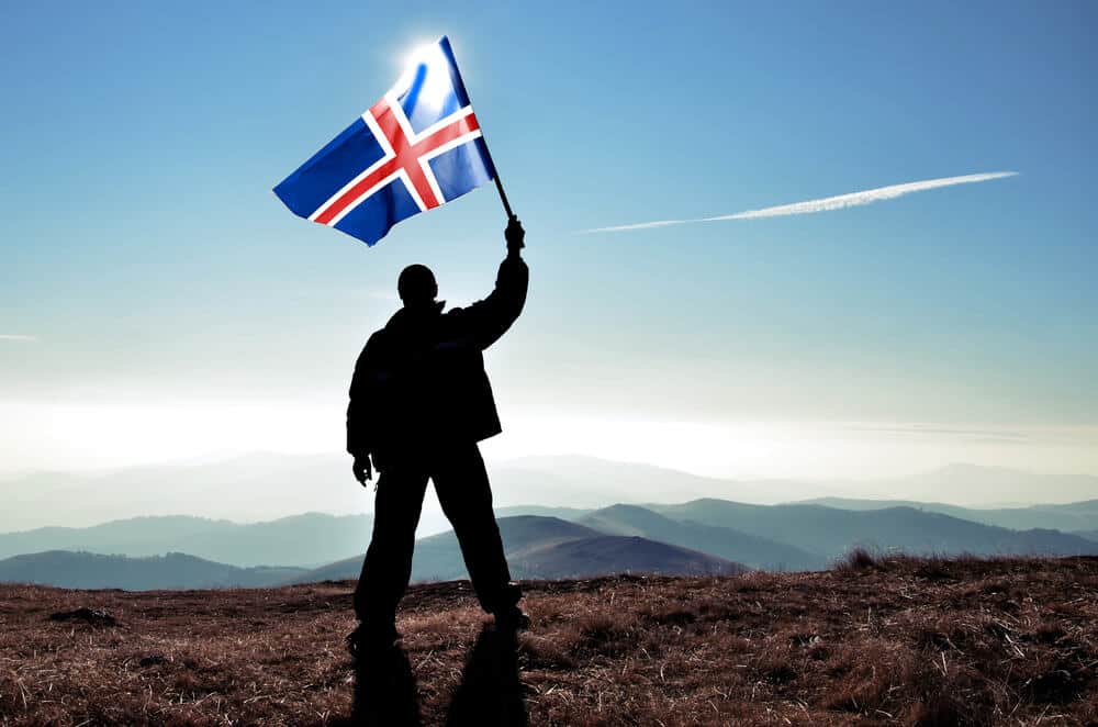 Man holding Iceland flag victoriously