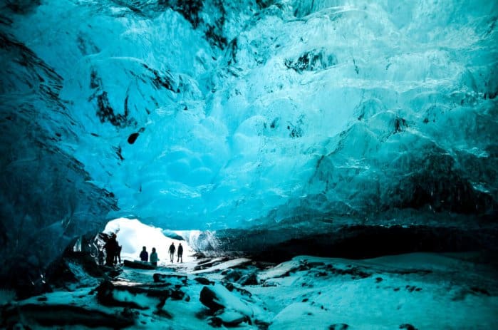 Exploring a blue glacier cave at Thingvellir National Park