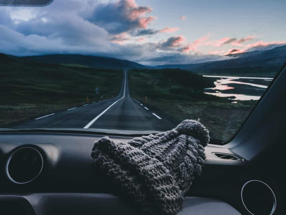 The Trip of a Lifetime: An Iceland Road Trip 2 Color streaked sky during Iceland road trip with hat on dashboard