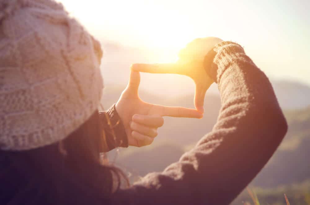 Woman looking at sunshine in Iceland in October