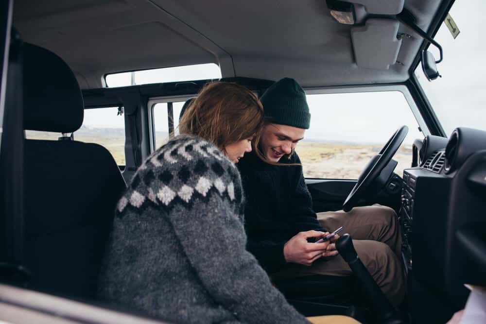 Friends enjoying a campervan road trip in Iceland