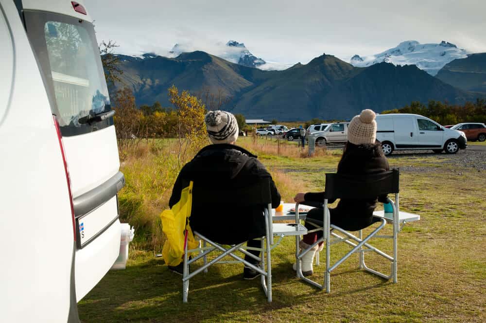 A couple enjoying breakfast during their Iceland campervan road trip