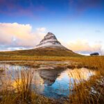 View from the field of Kirkjufell mountain and Kirkjufellsfoss waterfall in Snaefellsnes peninsula