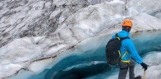 Man hiking on an Iceland glacier close to the crevice