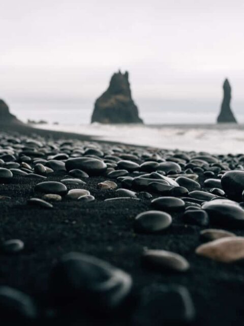 View of pebbles on Iceland's black sand beach Reynisfjara