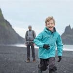 Little boy on beach with father; they have Icelandic family naming customs