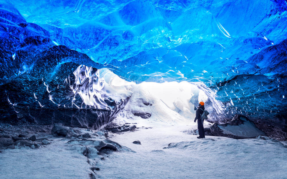 Tourist Visiting An Ice Cave Inside Of A Glacier In Iceland